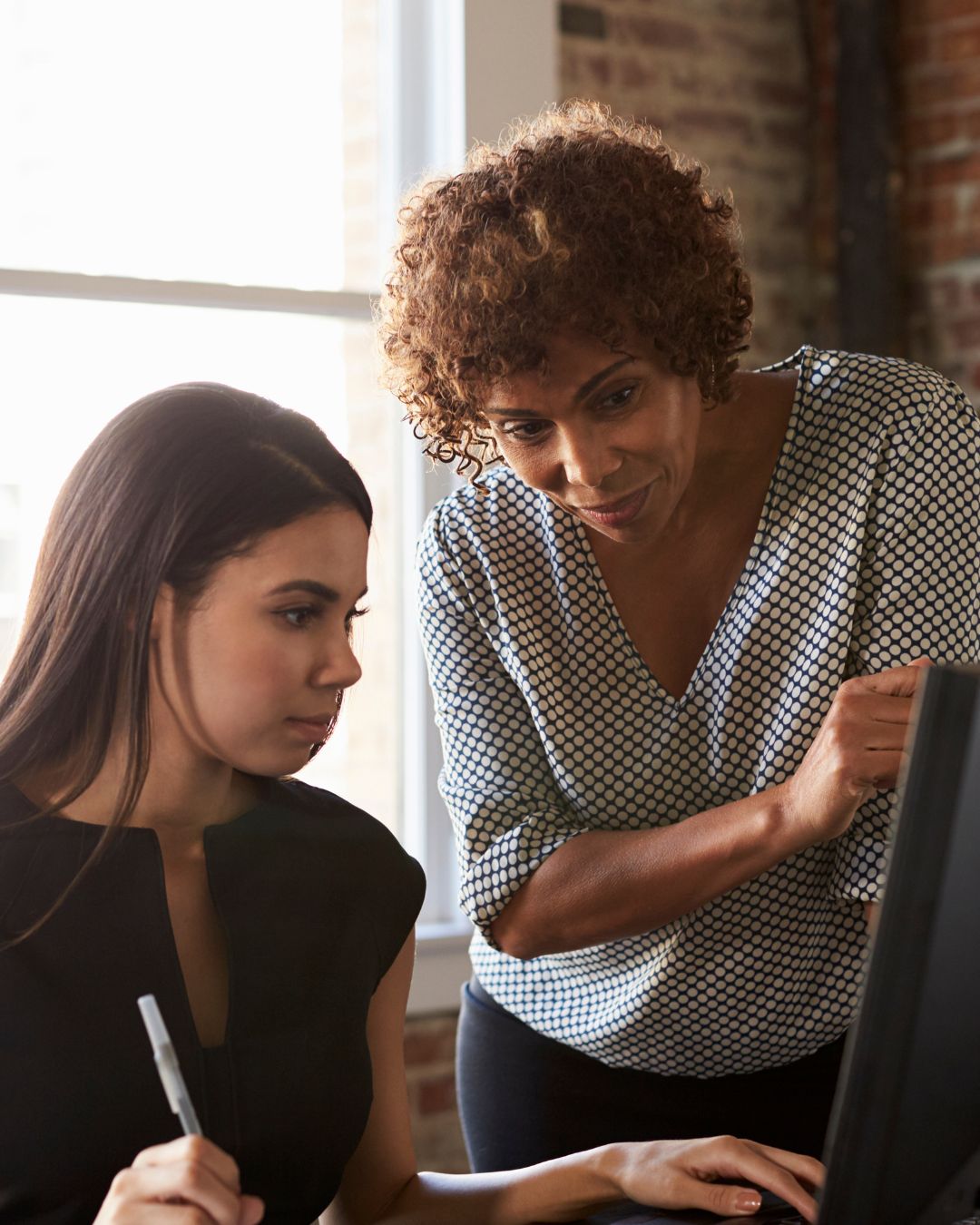 working together woman helping girl on computer
